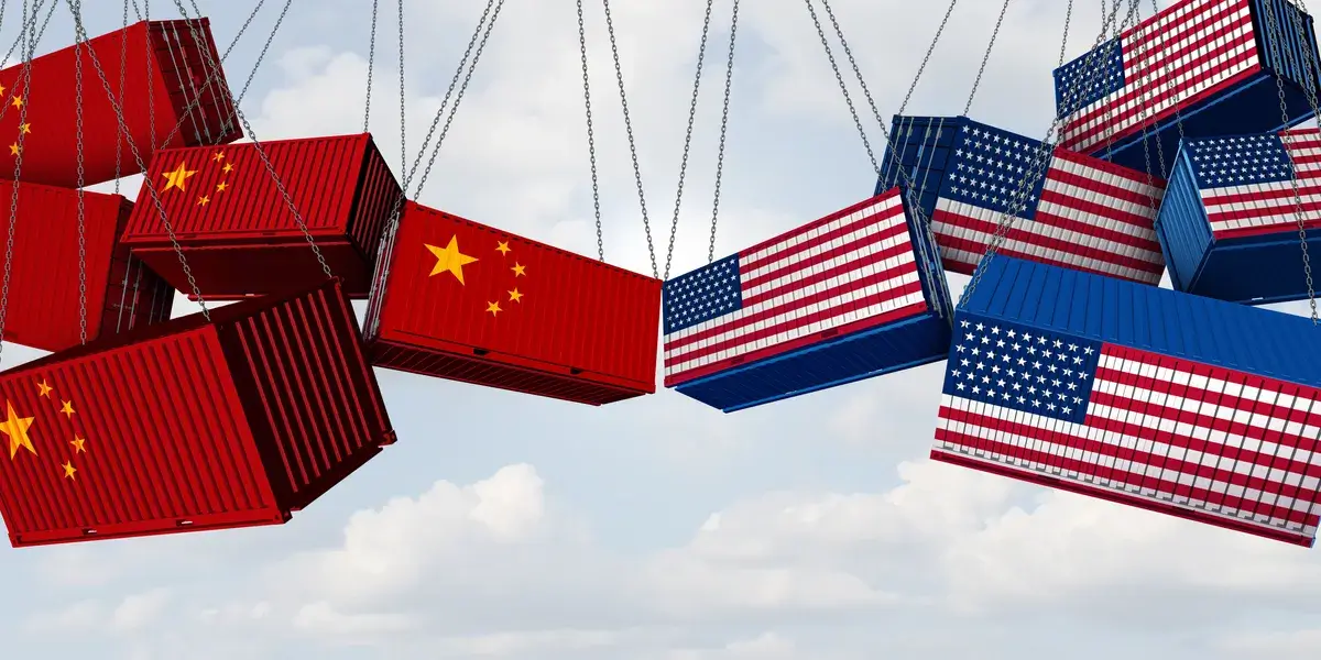 Containers with U.S. and China flags collide in midair, symbolizing trade tensions and a tariff war between the two countries.
