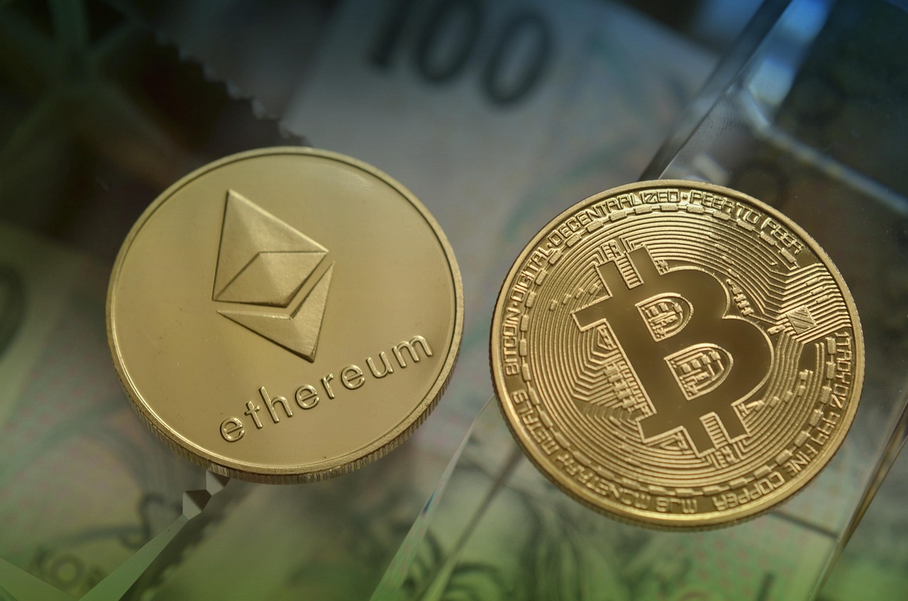 Physical Ethereum and Bitcoin coins side by side, symbolizing the main crypto assets in the digital market.